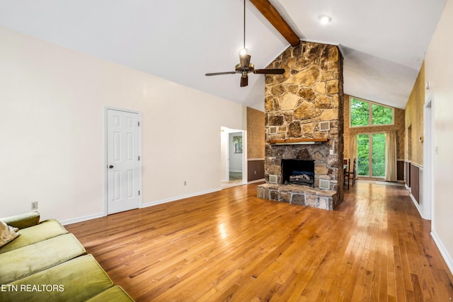 131 Clifton Cir, Oak Ridge, TN 37830 - unfurnished living room featuring hardwood / wood-style floors, a ceiling fan, beamed ceiling, a stone fireplace, and high vaulted ceiling