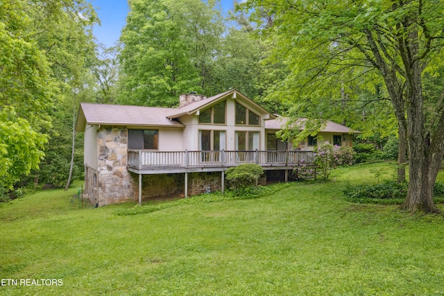 131 Clifton Cir, Oak Ridge, TN 37830 - back of house featuring stone siding, a chimney, a wooden deck, and a lawn
