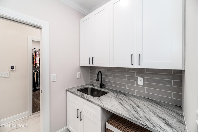 8304 Davis Ferry Rd, Loudon, TN 37774 - kitchen featuring a sink, baseboards, light stone counters, tasteful backsplash, and marble finish floor