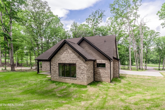 8304 Davis Ferry Rd, Loudon, TN 37774 - view of side of property with a yard, brick siding, and a shingled roof