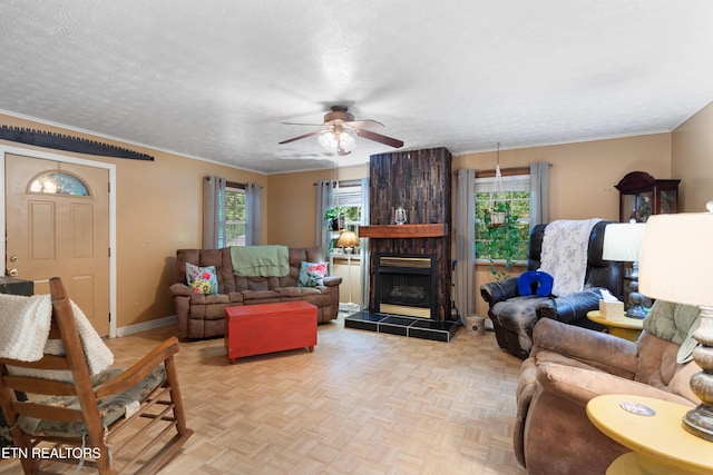 217 Jackson Dr, Harriman, TN 37748 - living room featuring healthy amount of natural light, ceiling fan, baseboards, ornamental molding, and a tile fireplace