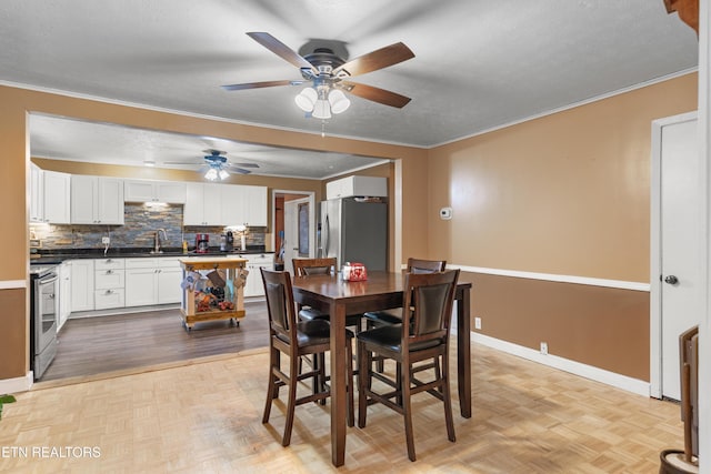 217 Jackson Dr, Harriman, TN 37748 - dining area featuring a ceiling fan, baseboards, ornamental molding, and parquet floors