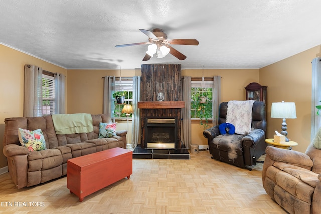 217 Jackson Dr, Harriman, TN 37748 - living area with ceiling fan, a textured ceiling, a tiled fireplace, and baseboards