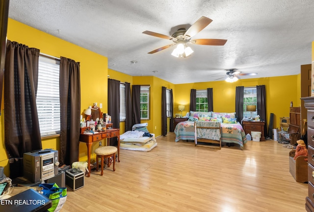 217 Jackson Dr, Harriman, TN 37748 - bedroom featuring a textured ceiling, light wood finished floors, and ceiling fan