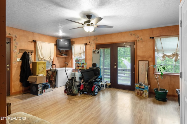 217 Jackson Dr, Harriman, TN 37748 - living room featuring wood finished floors, plenty of natural light, french doors, a ceiling fan, and a textured ceiling