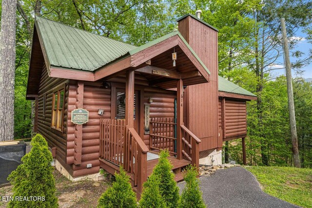614 Hillybilly Haven Way, Gatlinburg, TN 37738 - view of side of home featuring a chimney, log exterior, and metal roof