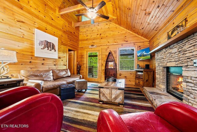 614 Hillybilly Haven Way, Gatlinburg, TN 37738 - living area with wood ceiling, wooden walls, a fireplace, and ceiling fan
