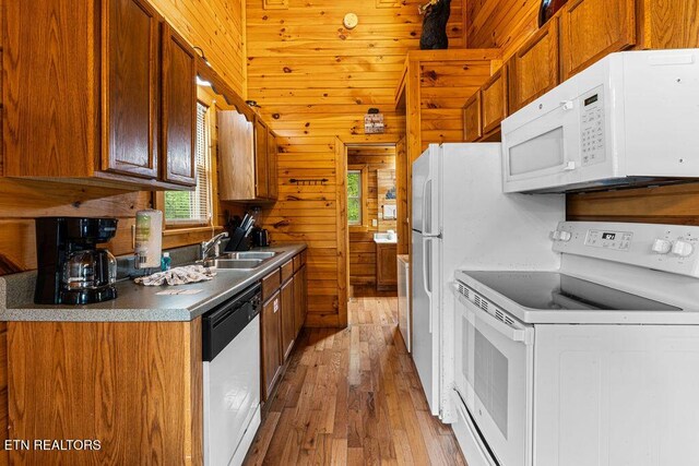 614 Hillybilly Haven Way, Gatlinburg, TN 37738 - kitchen featuring a sink, wood walls, white appliances, brown cabinets, and light wood-style flooring