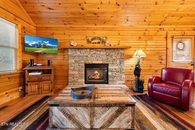 614 Hillybilly Haven Way, Gatlinburg, TN 37738 - living area featuring visible vents, vaulted ceiling, a fireplace, wooden walls, and wooden ceiling