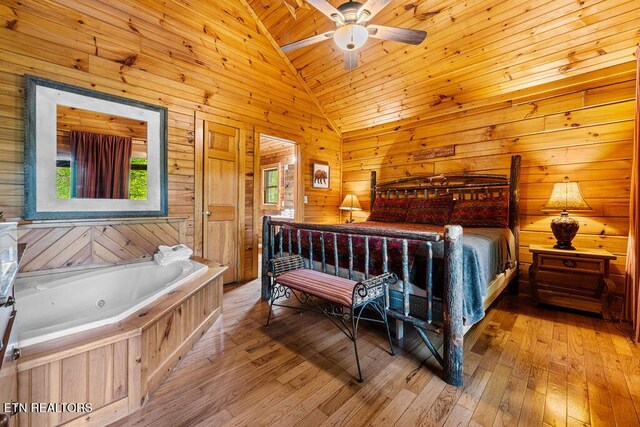 614 Hillybilly Haven Way, Gatlinburg, TN 37738 - bedroom featuring vaulted ceiling, wooden walls, wood ceiling, and hardwood / wood-style flooring