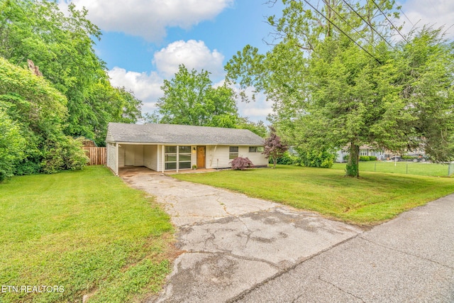 view of front of home with asphalt driveway and a carport