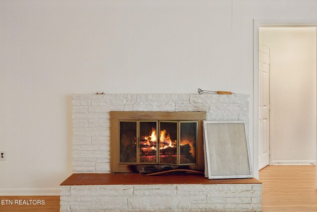 138 Lilac Dr, Lafollette, TN 37766 - detailed view of wood finished floors, baseboards, and a stone fireplace