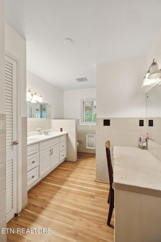 138 Lilac Dr, Lafollette, TN 37766 - full bathroom with tile walls, wood finished floors, vanity, wainscoting, and toilet
