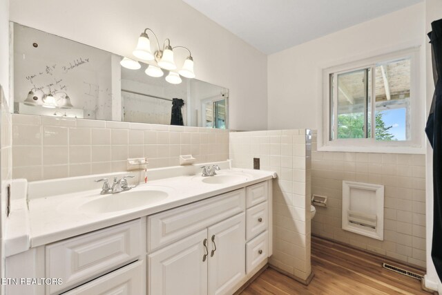 138 Lilac Dr, Lafollette, TN 37766 - full bathroom with tile walls, wood finished floors, toilet, double vanity, and curtained shower