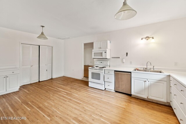 138 Lilac Dr, Lafollette, TN 37766 - kitchen with white appliances, a sink, decorative light fixtures, and light wood-style floors