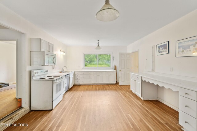 138 Lilac Dr, Lafollette, TN 37766 - kitchen featuring white appliances, light wood finished floors, light countertops, and a sink