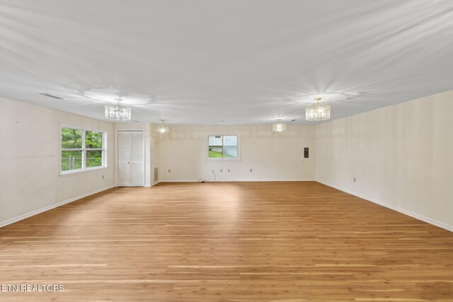 138 Lilac Dr, Lafollette, TN 37766 - spare room with a chandelier, light wood-type flooring, and baseboards