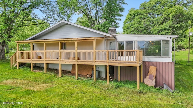 138 Lilac Dr, Lafollette, TN 37766 - back of property with a sunroom, a chimney, a yard, and a wooden deck