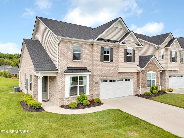 11842 Gecko Dr, Knoxville, TN 37932 - craftsman-style house featuring central AC, driveway, a garage, a standing seam roof, and brick siding