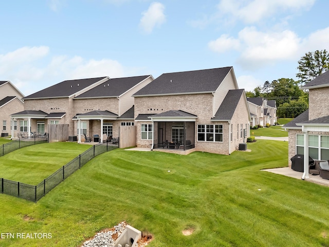 11842 Gecko Dr, Knoxville, TN 37932 - rear view of house featuring a sunroom, a patio area, brick siding, a shingled roof, and central air condition unit
