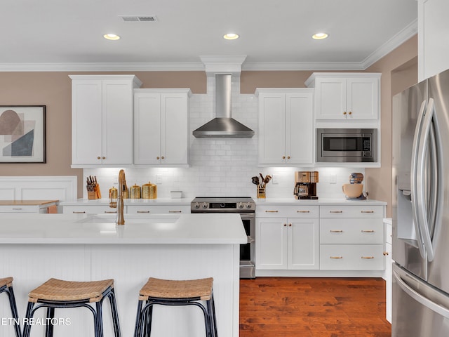 11842 Gecko Dr, Knoxville, TN 37932 - kitchen with appliances with stainless steel finishes, wall chimney range hood, a sink, a kitchen bar, and light countertops