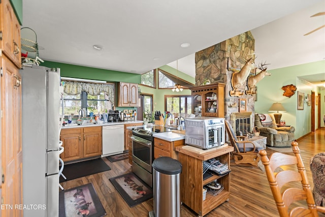 kitchen featuring dishwasher, freestanding refrigerator, electric range, light countertops, and ceiling fan