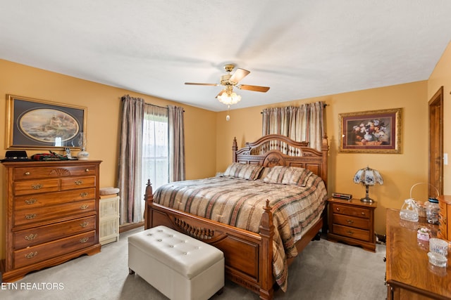 bedroom with light carpet and a ceiling fan