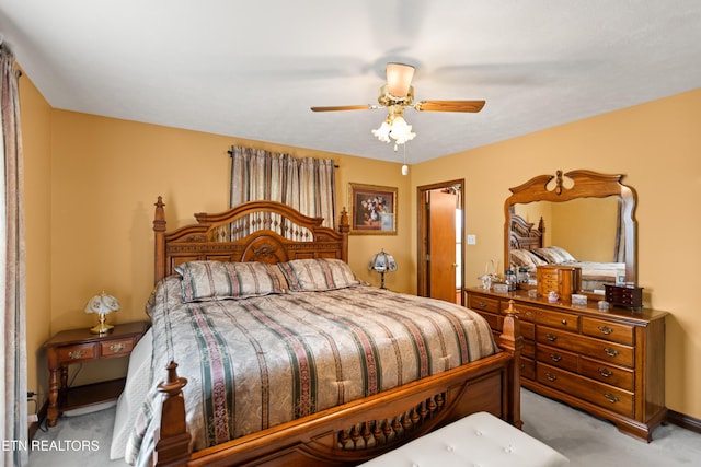 bedroom with light carpet and ceiling fan