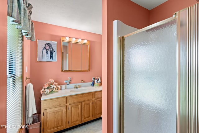 bathroom featuring a stall shower and vanity