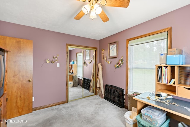 office area featuring ceiling fan, carpet flooring, and baseboards