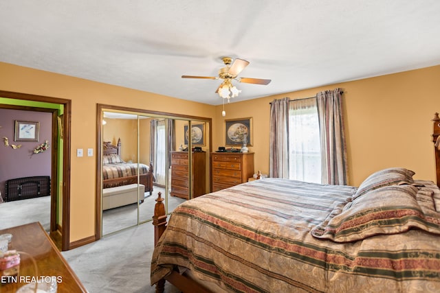 bedroom featuring light carpet, a closet, and a ceiling fan