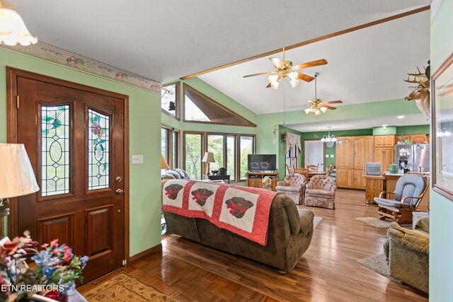 living area with lofted ceiling, a ceiling fan, and baseboards