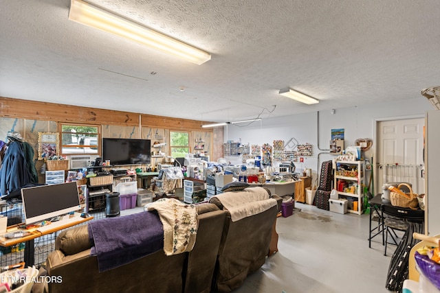 living area with a textured ceiling and concrete flooring