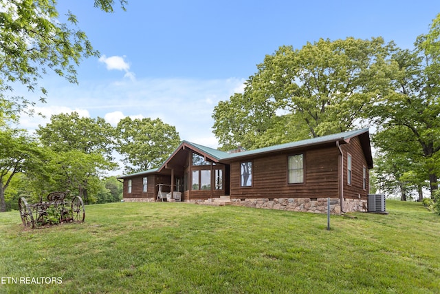 view of side of property with cooling unit and a yard