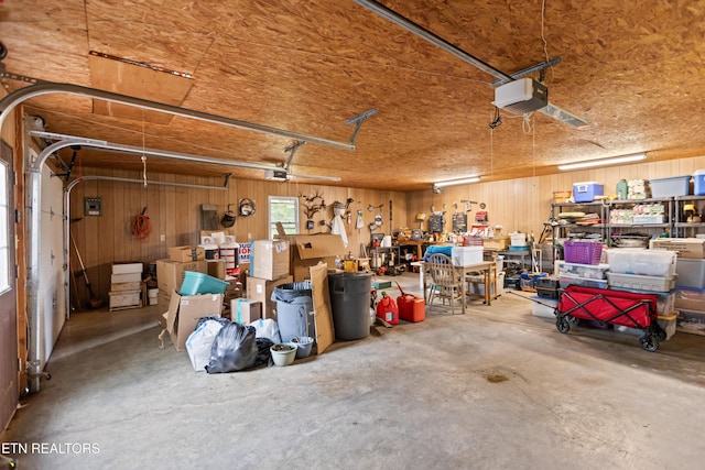 garage featuring wooden walls and a garage door opener