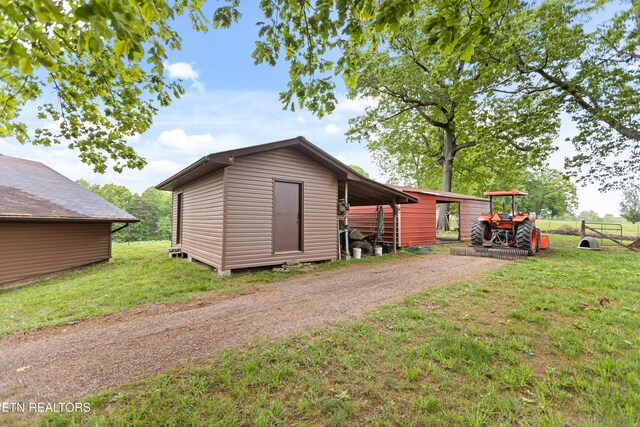 view of shed with dirt driveway