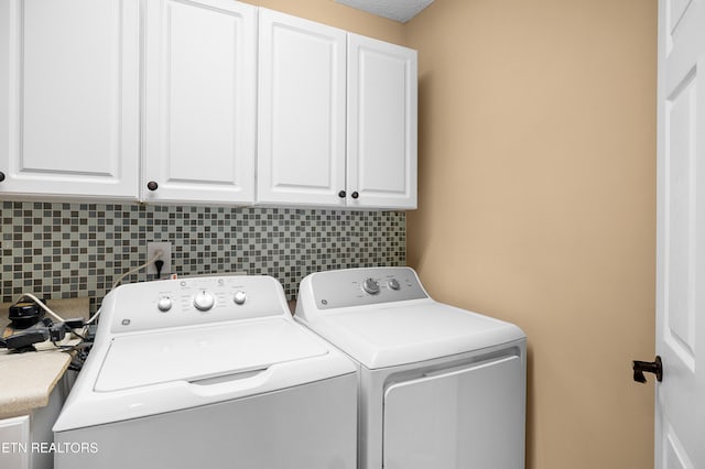 laundry area with cabinet space and washer and clothes dryer