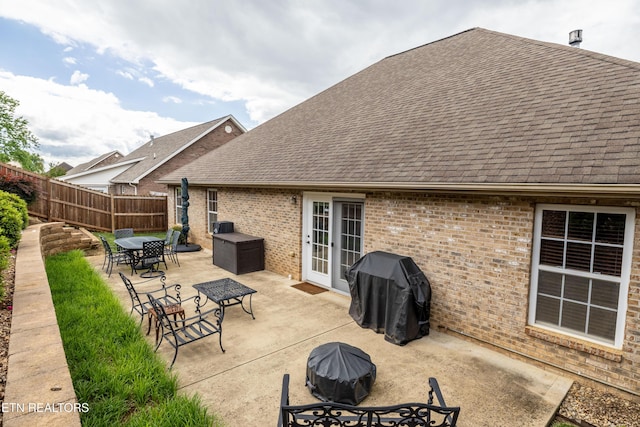 view of patio / terrace featuring outdoor dining area, fence, and a grill