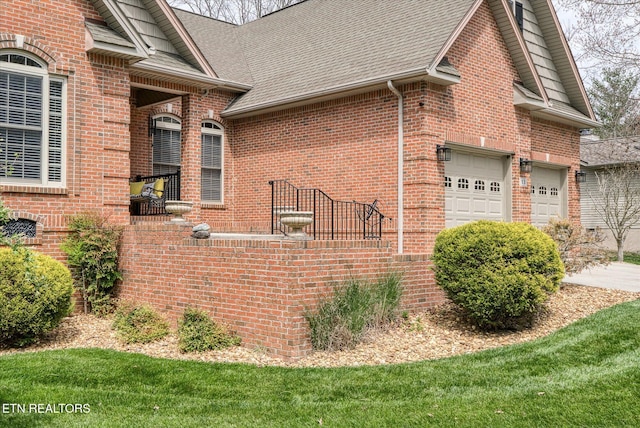 13 Holly Ct, Crossville, TN 38558 - view of side of home with brick siding, a shingled roof, an attached garage, and driveway