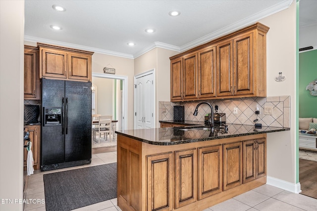 13 Holly Ct, Crossville, TN 38558 - kitchen with black refrigerator with ice dispenser, brown cabinetry, a sink, backsplash, and crown molding