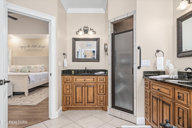 13 Holly Ct, Crossville, TN 38558 - ensuite bathroom featuring ornamental molding, a stall shower, tile patterned floors, two vanities, and baseboards