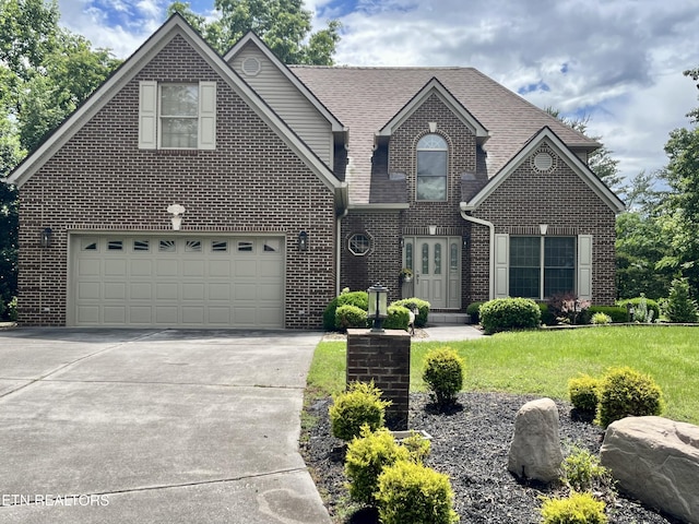 traditional home featuring brick siding, concrete driveway, a front lawn, an attached garage, and a shingled roof