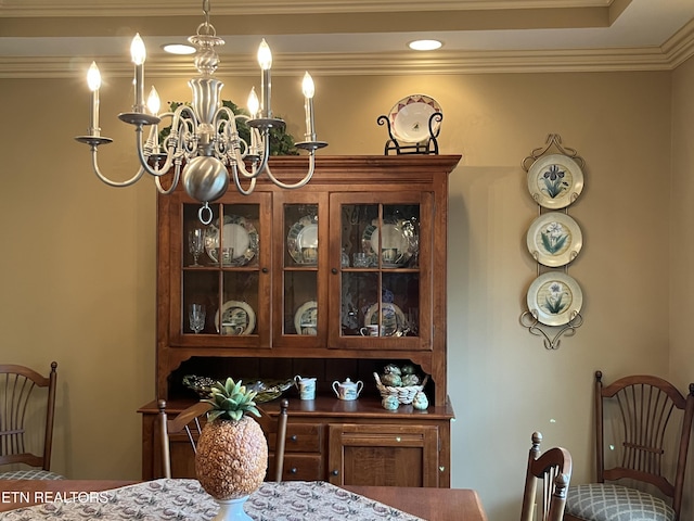 dining area with a chandelier and ornamental molding