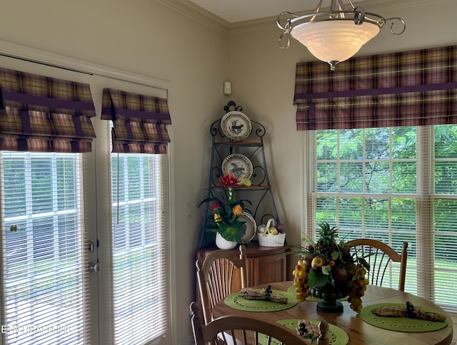 dining space with crown molding
