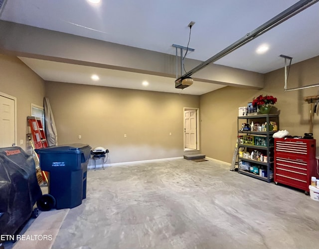 garage with recessed lighting, a garage door opener, and baseboards