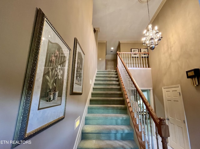 stairs with ornamental molding and a chandelier