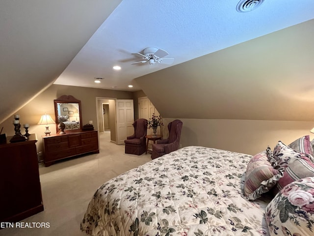 bedroom with light carpet, lofted ceiling, and a ceiling fan