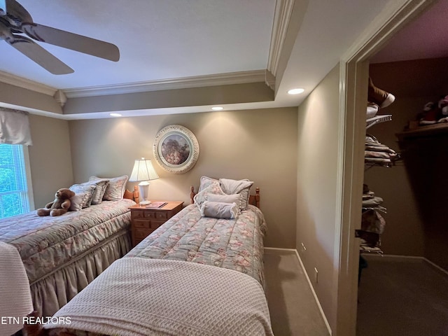 carpeted bedroom featuring crown molding, ceiling fan, baseboards, recessed lighting, and a spacious closet