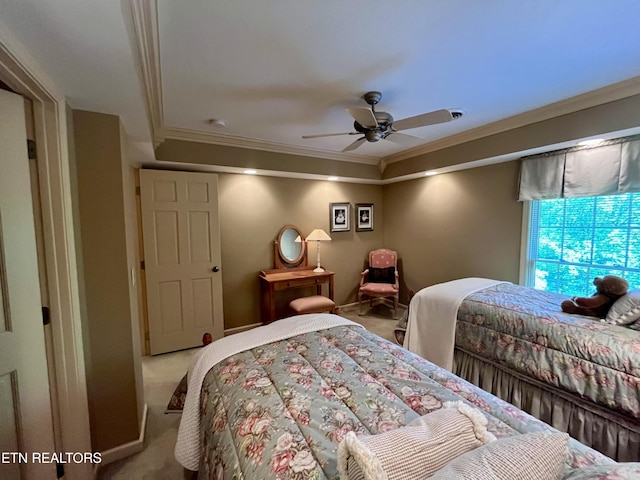 carpeted bedroom with ornamental molding and ceiling fan
