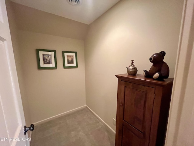 corridor with carpet and baseboards